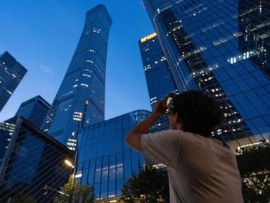 Small plane crash at Beijing high-rise kills the pilot and injures 13, authorities say